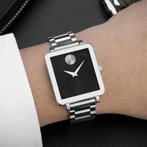 Detailed shot of a sleek square quartz watch on wrist, featuring a minimalist black dial.