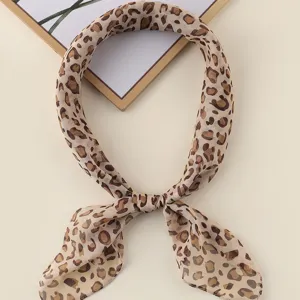 Leopard print square scarf detail view, soft chiffon neckerchief close-up texture.