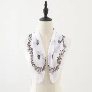 White chiffon square scarf detail with elegant floral vine border print and soft lightweight fabric.