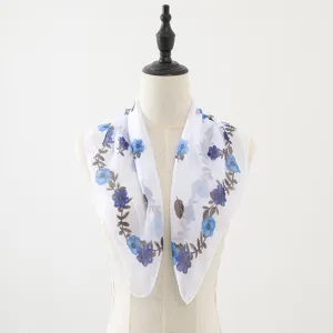 Close-up of the blue floral print chiffon square scarf showing soft fabric and fine details.