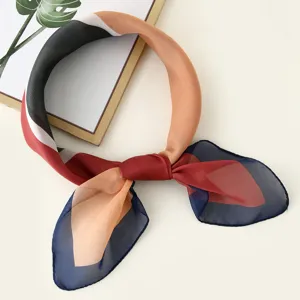 Elegant color-blocked square scarf detail, lightweight fabric with chic geometric print design.