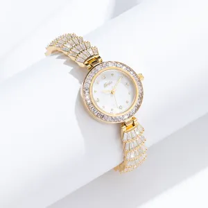 Luxury gold women watch with sparkling crystal encrusted bezel and elegant bracelet strap.