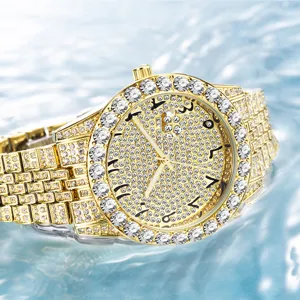 Detailed close-up of luxury men gold iced out quartz watch with sparkling rhinestones and big dial.