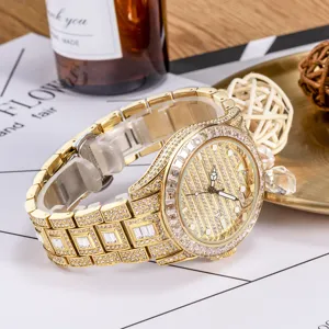 Luxury iced out gold quartz watch close up, diamond paved dial and polished steel strap.
