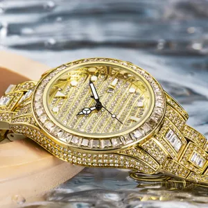 Detailed close-up of a luxury gold iced-out rhinestone quartz watch dial and sparkling bezel.