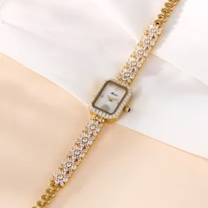 Luxus goldene Damen Quarzuhr mit glitzerndem Zifferblatt und Strasstein Armband.
