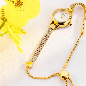 Close-up detail of luxury gold women rhinestone watch with sparkle dial and slider chain.