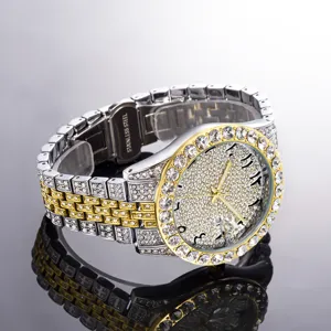Luxury mens iced out rhinestone quartz watch with gold and silver dual tone steel strap.
