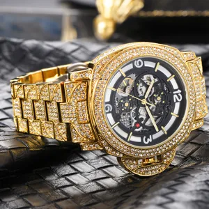 Men gold iced out automatic mechanical watch with skeleton dial and rhinestone details.