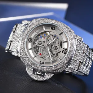 Detailed view of luxury iced out skeleton mechanical watch with diamond bezel and crown guard.