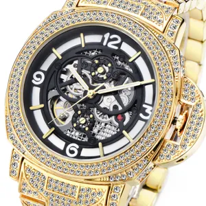 Luxury gold automatic mechanical watch for men with full diamond bezel and skeleton dial detail.