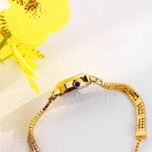Womens luxury gold quartz watch featuring a classic chain strap and elegant blue crystal crown.