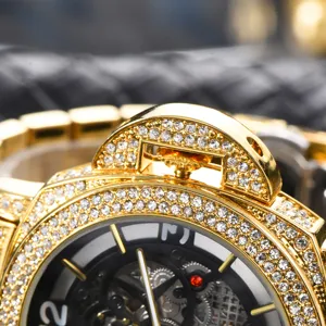Close-up detail of luxury gold iced out mechanical watch dial with crystal rhinestone bezel.