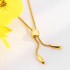 Gold adjustable chain detail featuring a sliding bead and sleek metal ends on clean white.