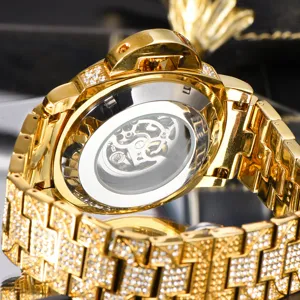 Gold mechanical watch detail, iced out rhinestone bezel, transparent skeleton back view.