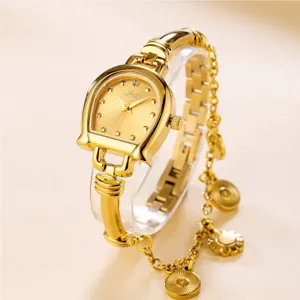 Gold horseshoe quartz watch detail view featuring chain strap and elegant crystal dial.