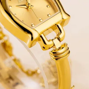Gold tone women quartz watch detail, unique horseshoe link design, elegant luxury style.