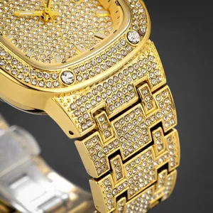 Close-up detail view of luxury gold-plated men iced-out rhinestone square quartz watch face.