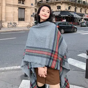 Detailed scene shot of grey plaid fringe shawl scarf, stylish autumn winter fashion wear.