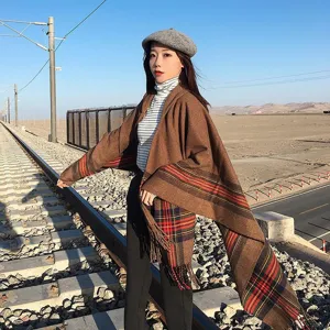 Details of the brown imitation cashmere shawl scarf with tartan plaid and fringe.
