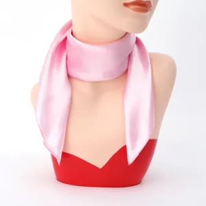 Detail shot of pink silk square scarf, smooth texture neckerchief for women's summer styling.