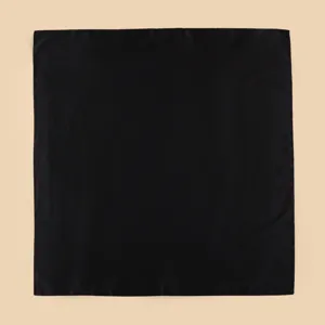 Detailed view of minimalist solid black square scarf, perfect for summer vacation style.