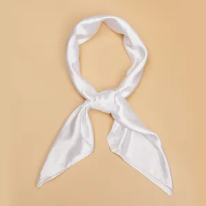 Close-up detail of a minimalist white satin silk neck scarf, smooth texture, elegant look.
