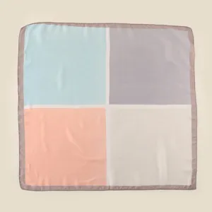 Close-up detail of the four-color block silk feel square scarf with delicate rolled edge.