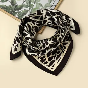 Detail view of women's 60x60cm black and white abstract print square scarf with dark border.