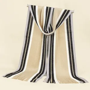 Detailed close-up of the knitted striped scarf texture, fringe details, and color block design.