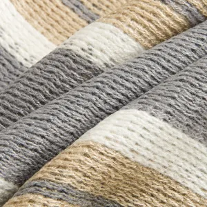 Close up detail showing the soft knitted texture of the striped winter scarf fabric.