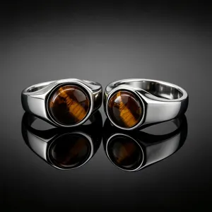 Detail shot of men's stainless steel rings featuring natural tiger eye stone with polished shine.
