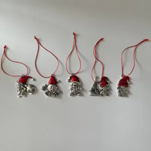 Metal Christmas gnome tree ornaments set of 5 with red hanging cords detailed holiday decor.