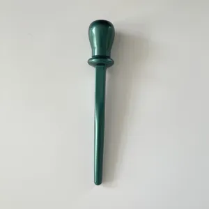 Metallic green silicone eyeliner tool detail, precise makeup applicator wand closeup view.