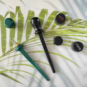 Silicone eyeliner tool detail shot with gel eyeliner jars and professional brush applicator.