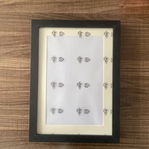 Black wooden kids art picture frame with A4 white mat mount for displaying child drawings.