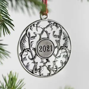 Detailed close-up of a silver metal Christmas tree ornament with 2021 engraved.