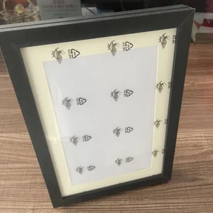 Detailed view of black wooden photo frame with white mat for artwork and A4 pictures.