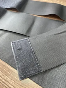 Detailed view of elastic waist bandage wrap, showing velcro closure and breathable fabric texture.
