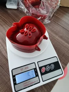 Detail shot of a red apple shaped hand pie mold placed on a digital scale for weight display.