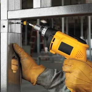 Magnetic screw drill tip detail shot showing electric drill in action on metal frame.