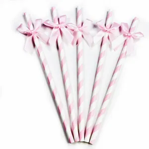 Pink and white striped paper straws with cute bows, perfect for birthday party decor.