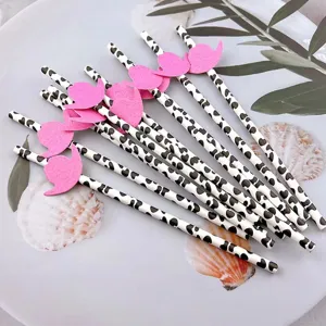 Cow print paper straws with pink party hat decoration, disposable cute drink accessories for events.