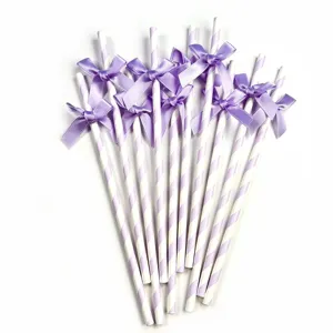 Purple striped paper straws decorated with cute satin bows, ideal for party and birthday decor.