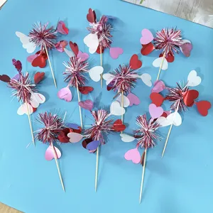 Detail view of heart-shaped tassel cake topper decorations, perfect for Valentine's day parties.