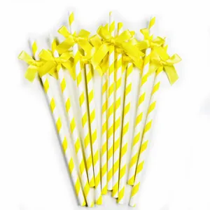 Yellow striped paper straws with cute bows, perfect for birthday parties and dessert tables.