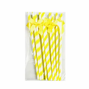 Yellow striped paper straws with bows for party decoration, birthday celebration and dessert table.
