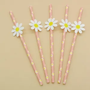 Detailed view of pink paper drinking straws featuring cute white daisy flower patterns.