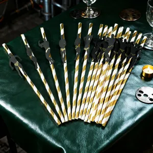 Gold and white striped paper straws featuring funny muscle man cutouts for party decor.
