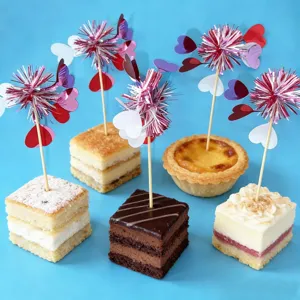 Detailed view of Valentine's day decorative cake picks with sparkly tinsel and cute hearts.